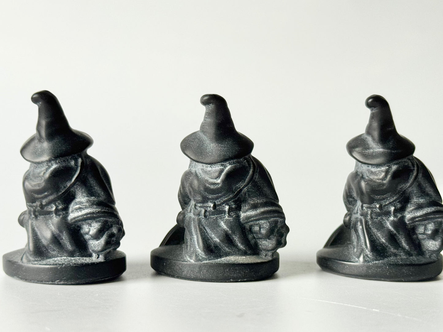 Witch with broom, black obsidian carving