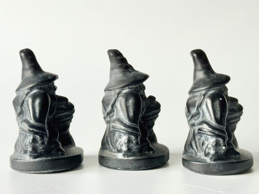 Witch with broom, black obsidian carving