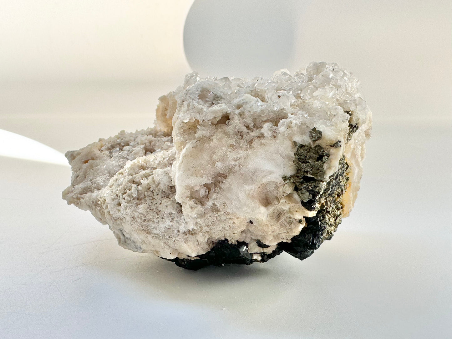 Calcite with pyrite, quartz, and galena (or tetrahedrite)