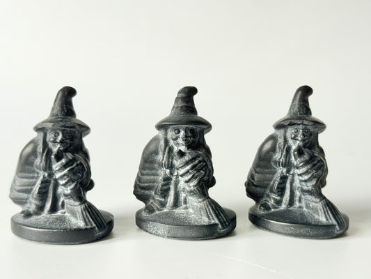 Witch with broom, black obsidian carving